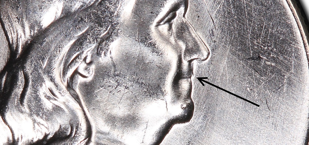 1957 Franklin half dollar Bugs Bunny variety close-up showing die clash spike marks on Franklin's upper lip resembling buck teeth