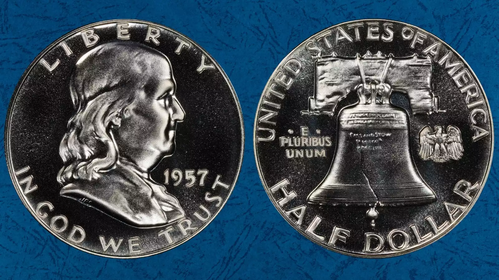 1957 Proof Franklin half dollar Tripled Die Reverse FS-801 close-up showing dramatic tripling on reverse lettering UNITED STATES OF AMERICA