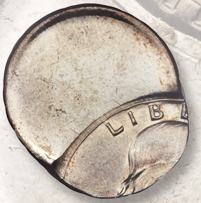 1957 Franklin half dollar off-center strike error showing significant off-center displacement with blank planchet area visible